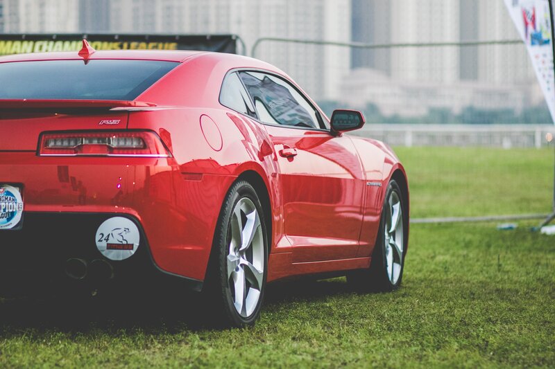 Red sports car on grass