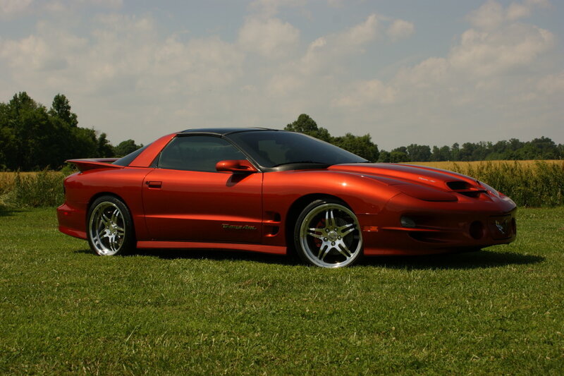 Red sports car on grass field