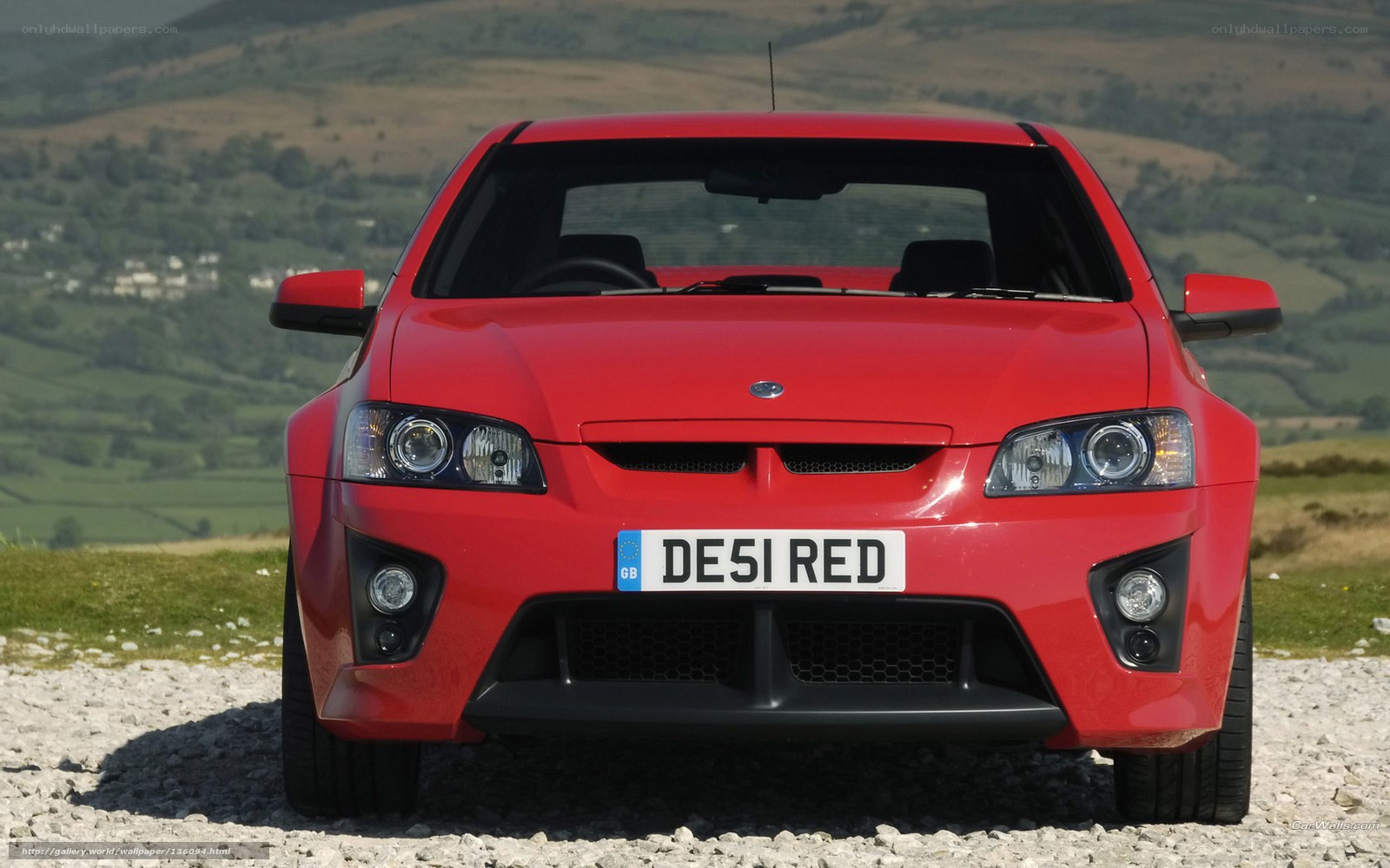 red sports car on gravel