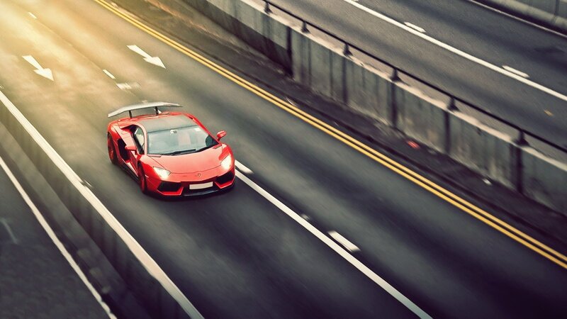 Red sports car on highway