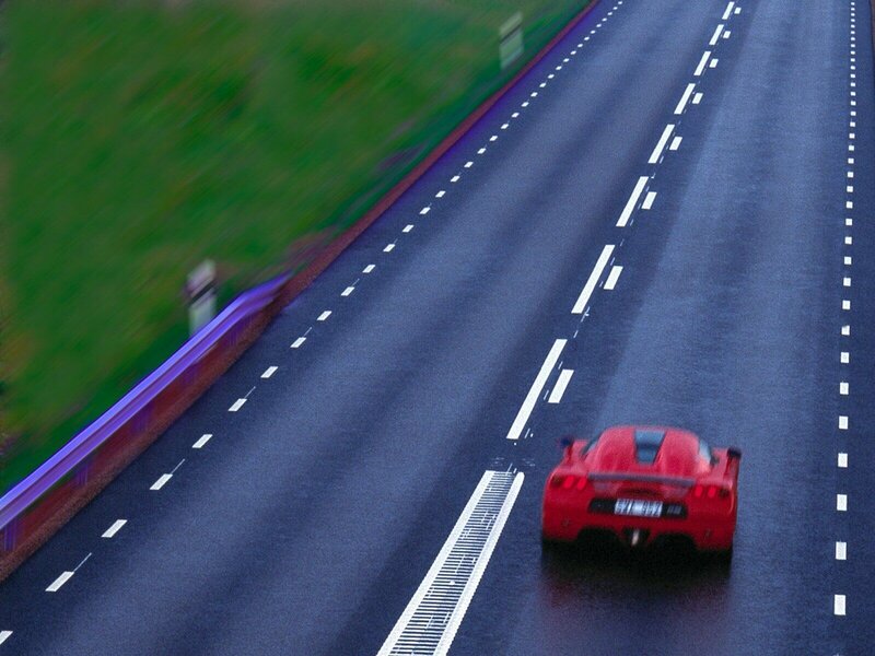 Red sports car on highway