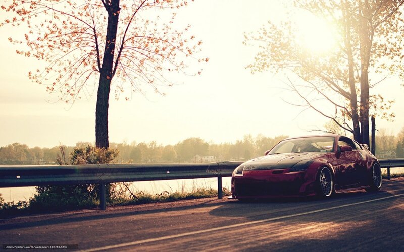 Red sports car on lakeside road