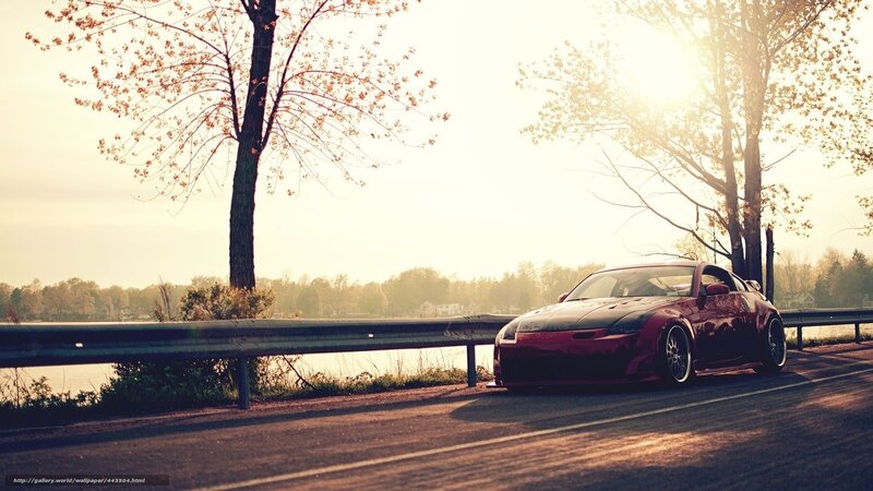 Red sports car on lakeside road