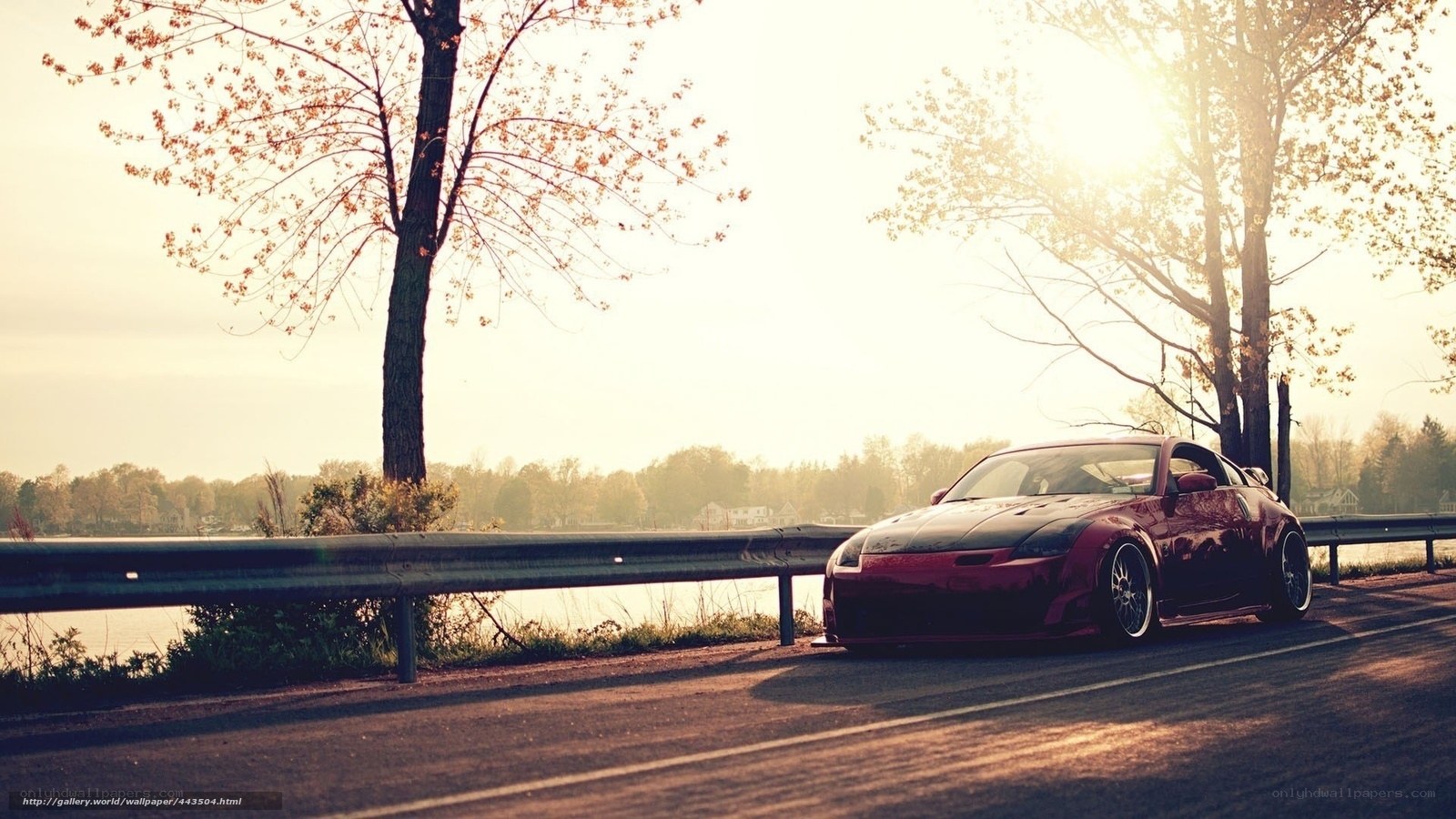 Red sports car on lakeside road