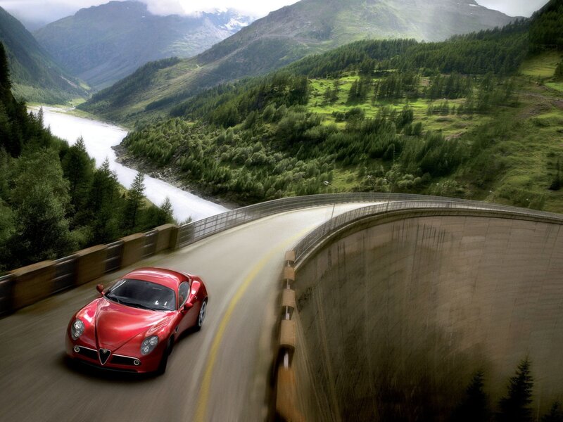 Red sports car on mountain road