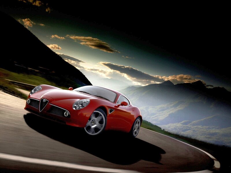 Red sports car on mountain road