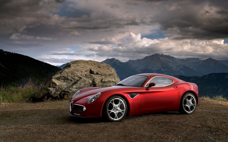 Red sports car on mountain road