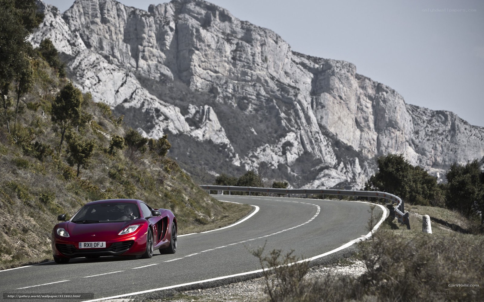 Red sports car on mountain road