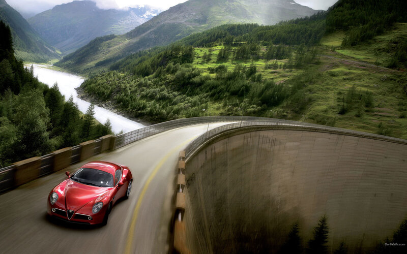 Red sports car on mountain road