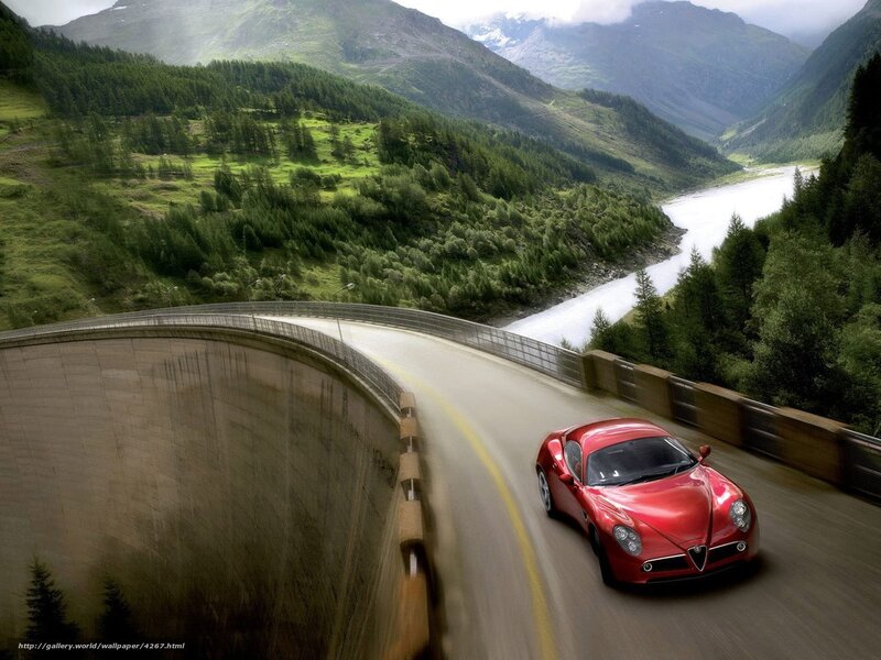 Red sports car on mountain road