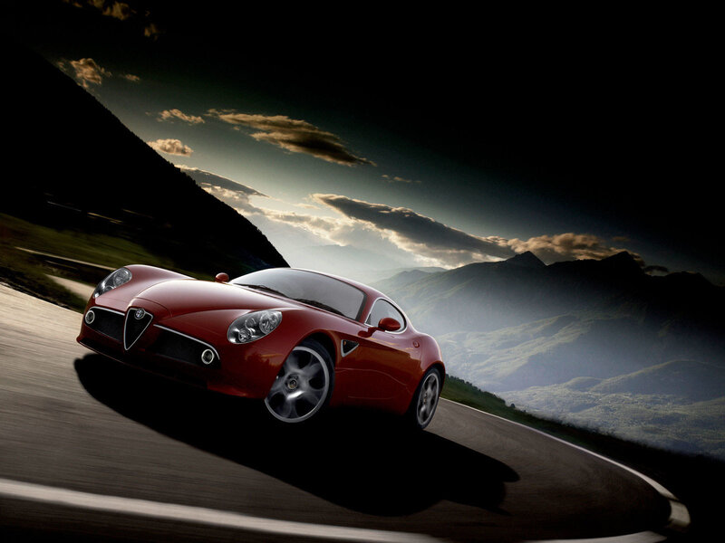 Red sports car on mountain road
