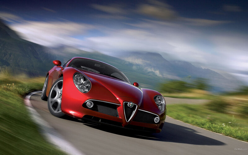 Red sports car on mountain road
