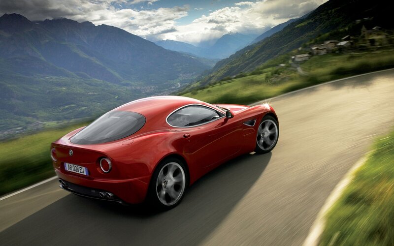Red sports car on mountain road