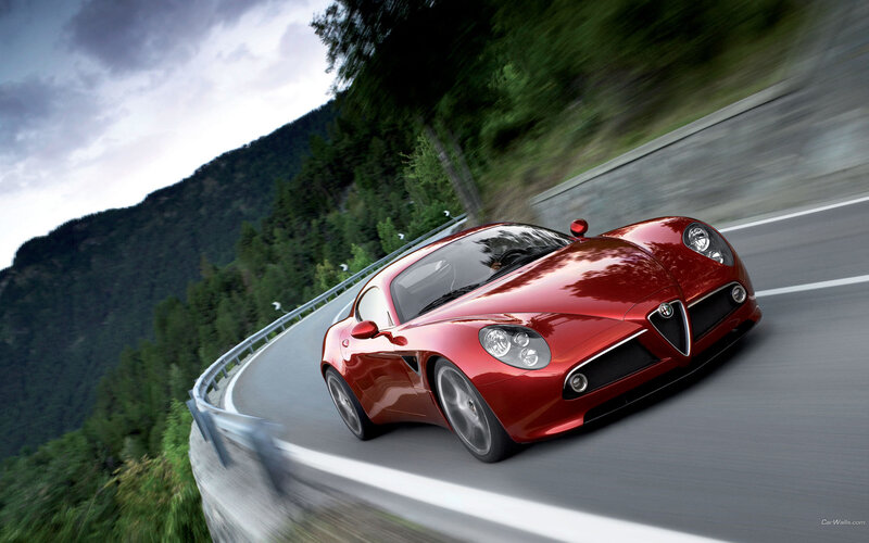 Red sports car on mountain road