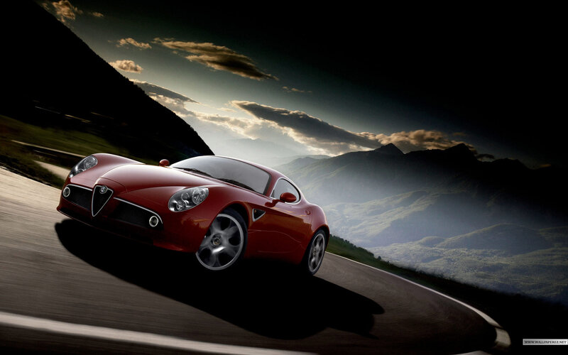 Red sports car on mountain road