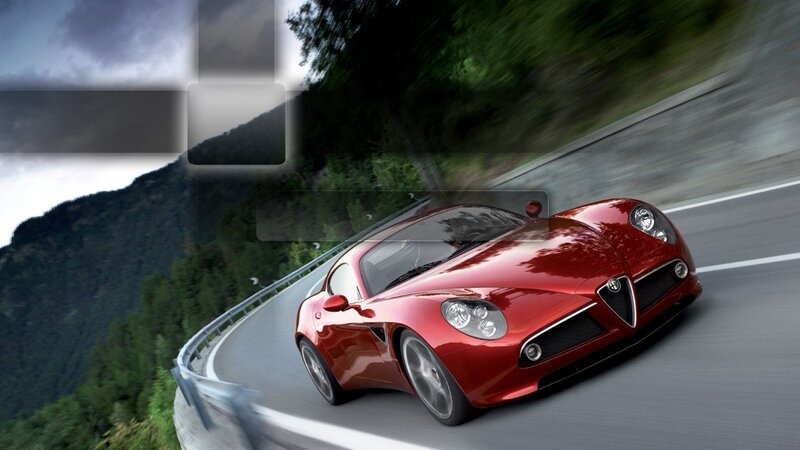 Red sports car on mountain road