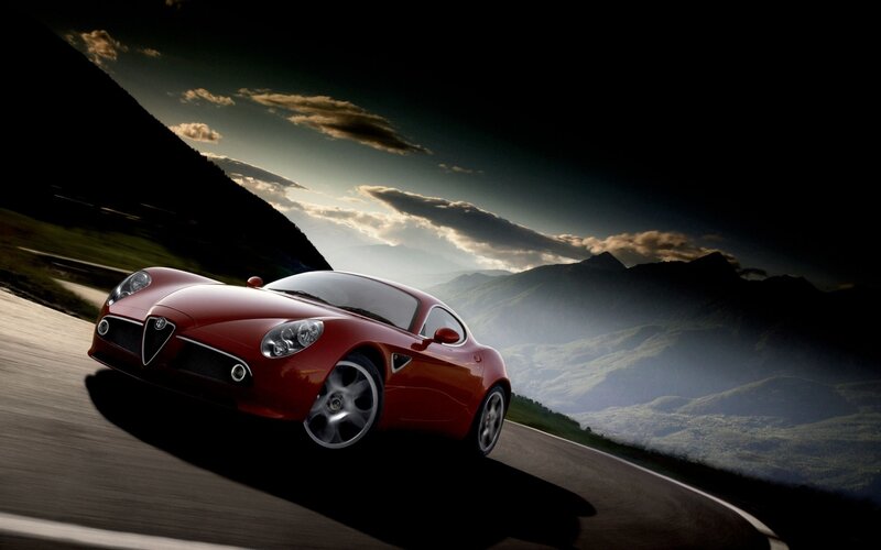 Red sports car on mountain road