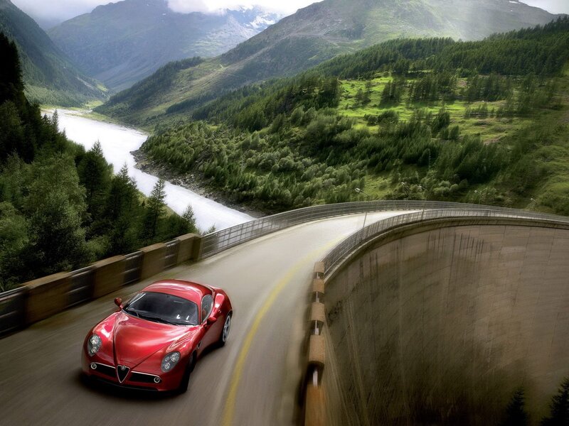 Red sports car on mountain road