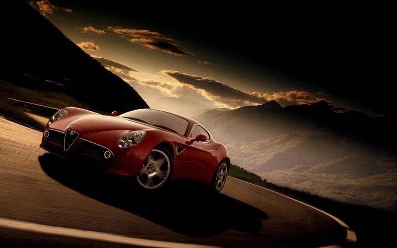 Red sports car on mountain road