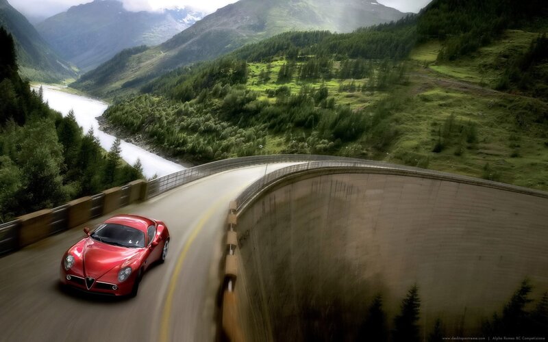 Red sports car on mountain road