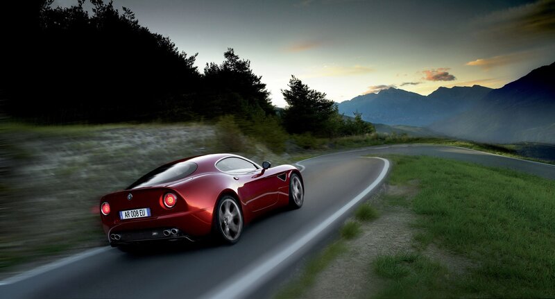 Red sports car on mountain road