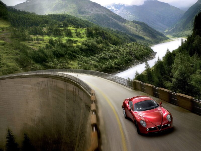 Red sports car on mountain road