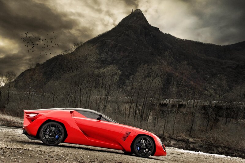 Red sports car on mountain road