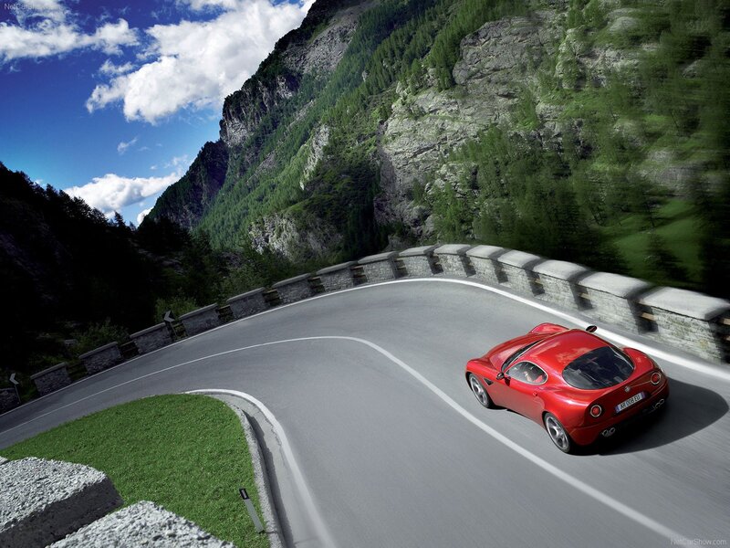 Red sports car on mountain road