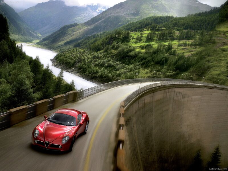 Red sports car on mountain road