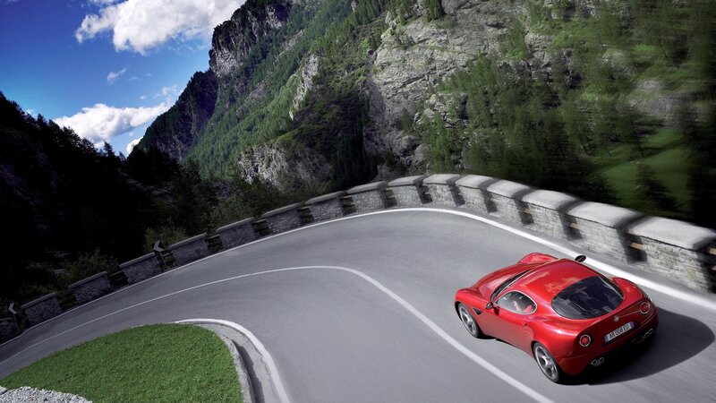 Red sports car on mountain road