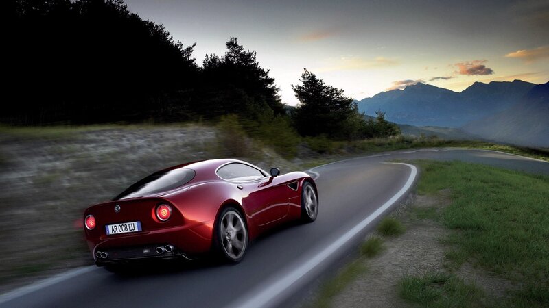red sports car on mountain road