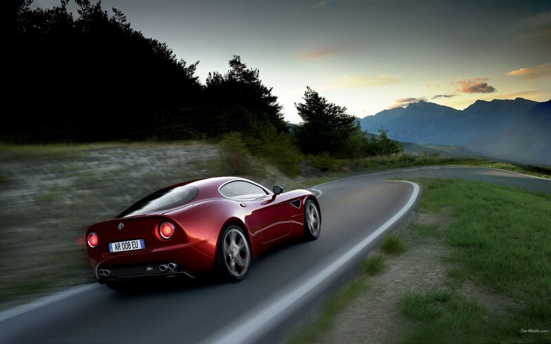 Red sports car on mountain road