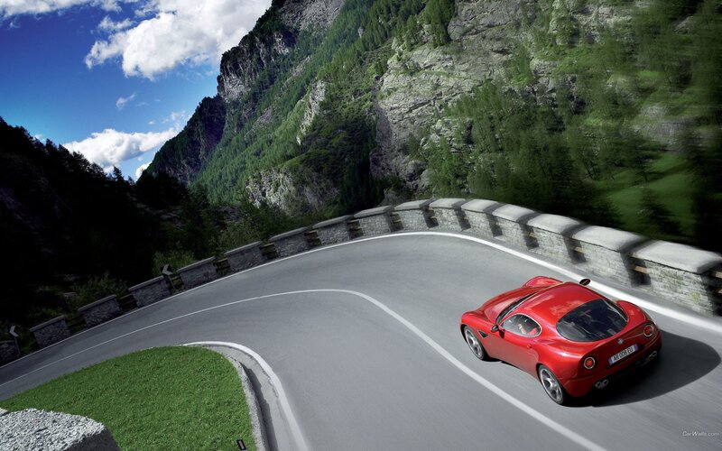Red sports car on mountain road
