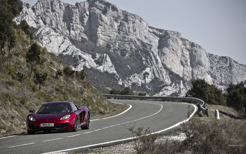 Red sports car on mountain road