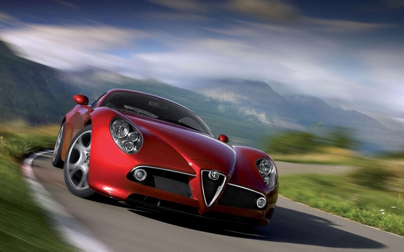 Red sports car on mountain road
