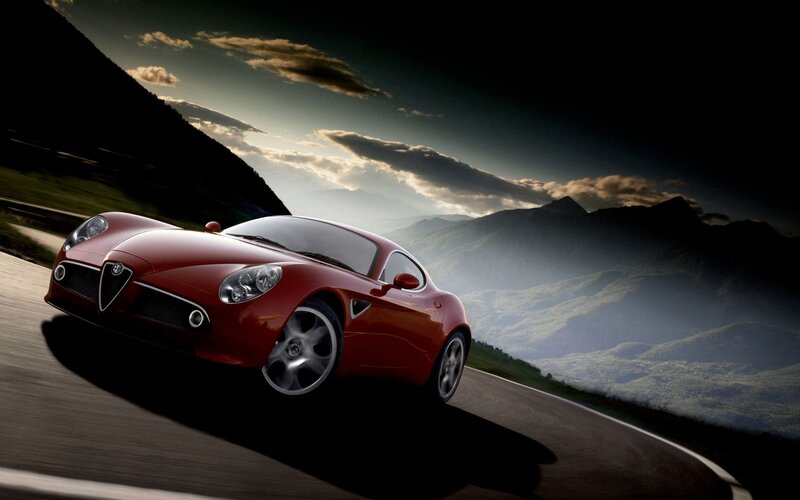 Red sports car on mountain road