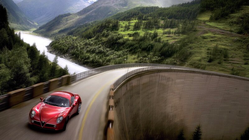 Red sports car on mountain road