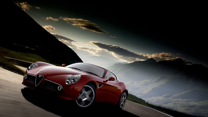 Red sports car on mountain road