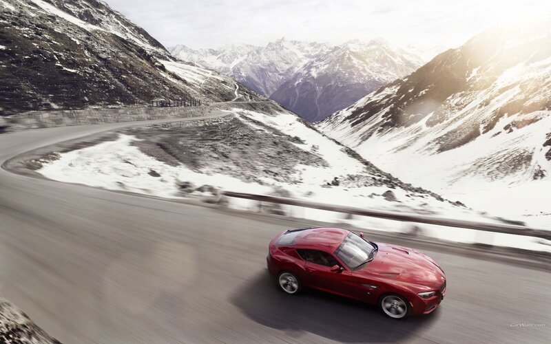 Red sports car on mountain road