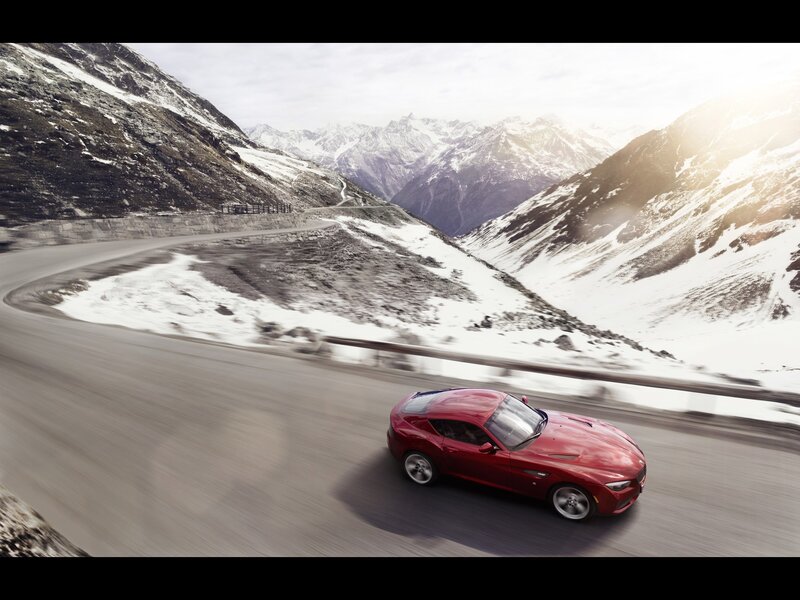 Red sports car on mountain road