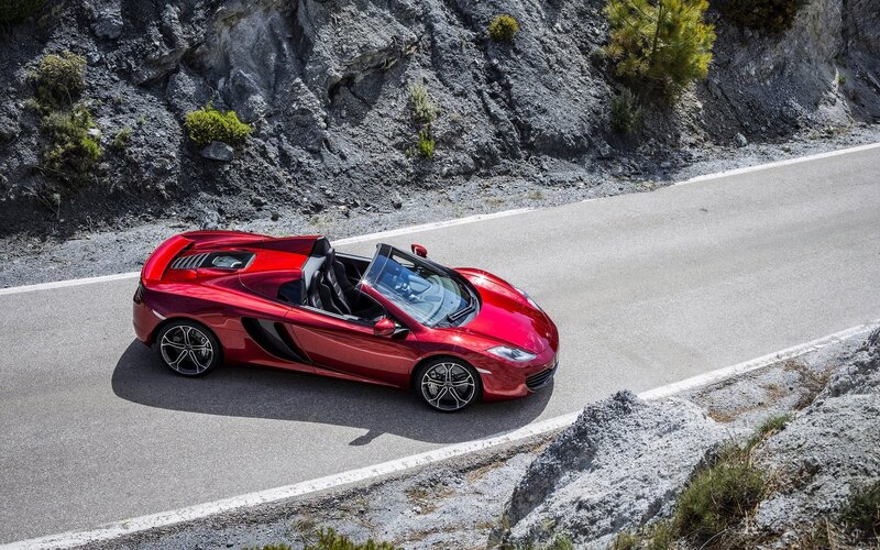 Red sports car on mountain road