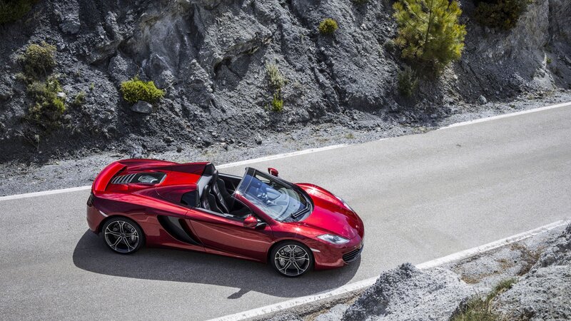 Red sports car on mountain road