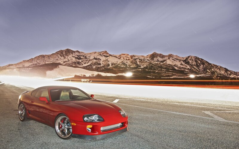 Red sports car on mountain road
