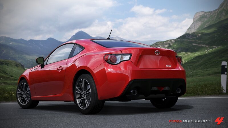 Red sports car on mountain road