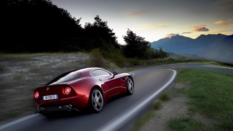 Red sports car on mountain road