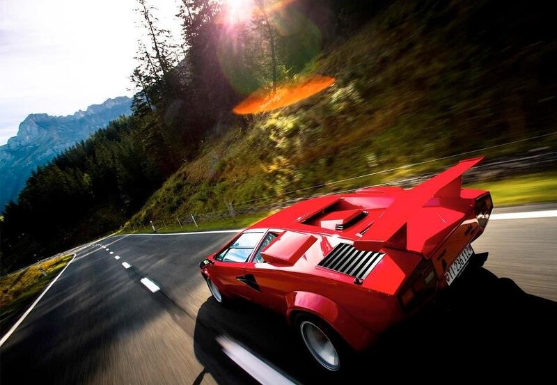 Red sports car on mountain road