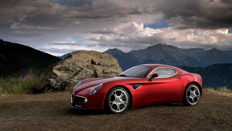 Red sports car on mountain road