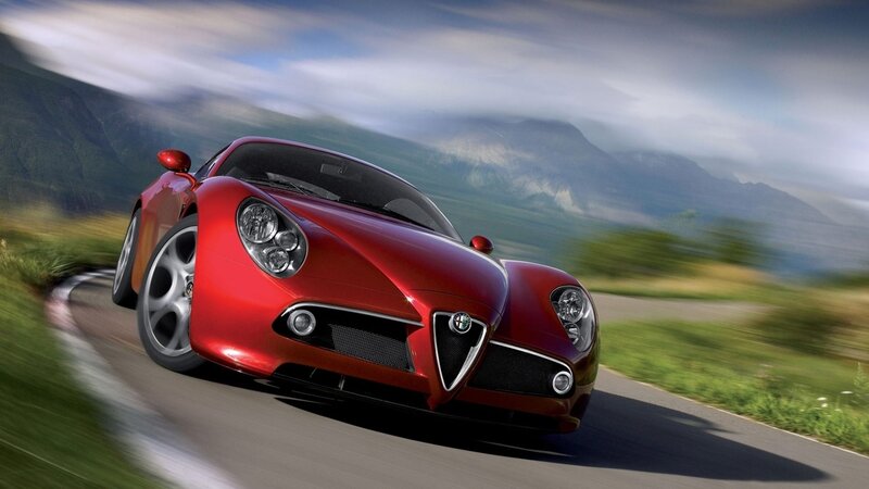 Red sports car on mountain road