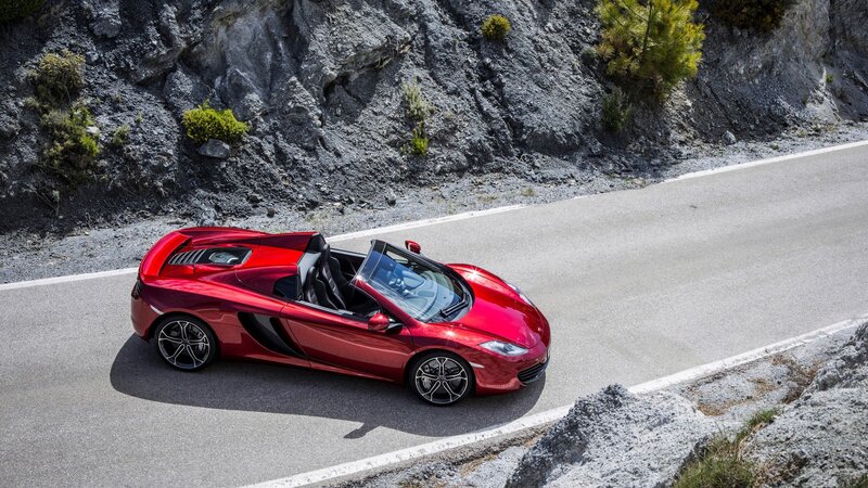 Red sports car on mountain road