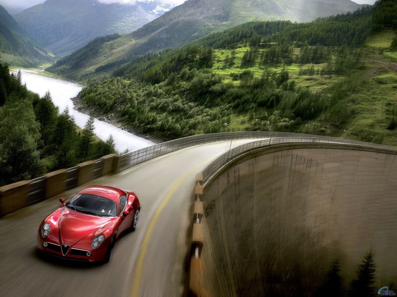 Red sports car on mountain road